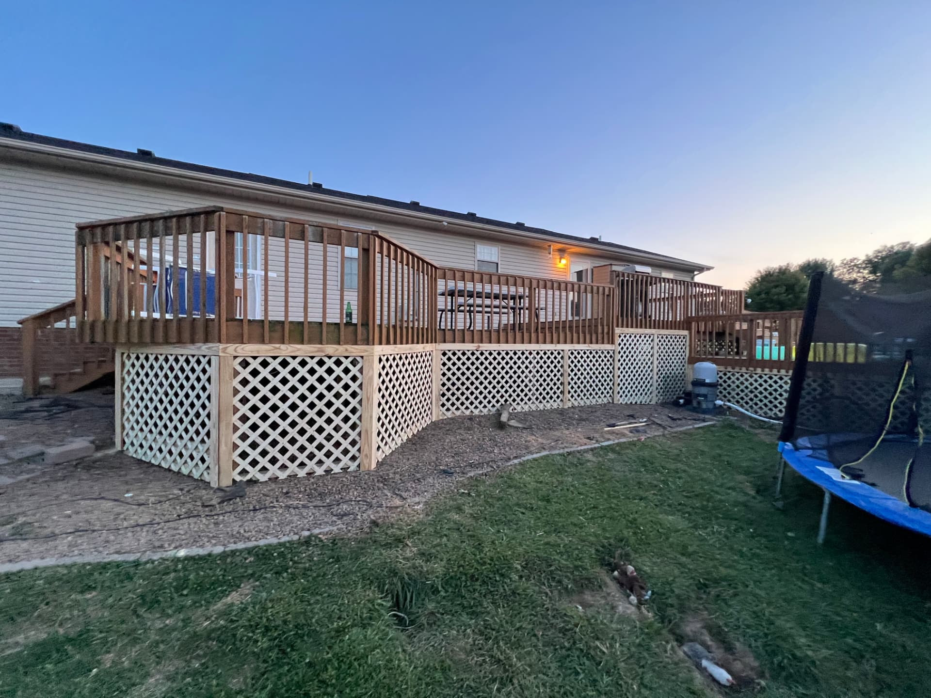 Wood deck with fresh lattice skirting and corner privacy panels